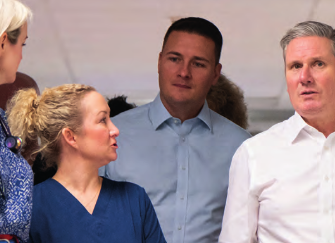 Streeting and Starmer look characteristically gormless, while an unnamed nurse has a word with them.